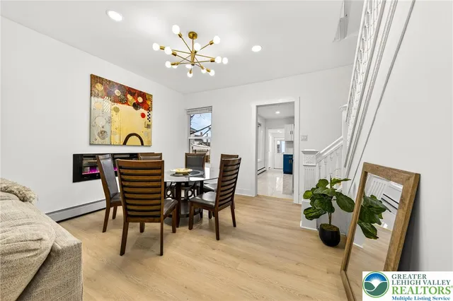 a view of a dining room with furniture and a chandelier