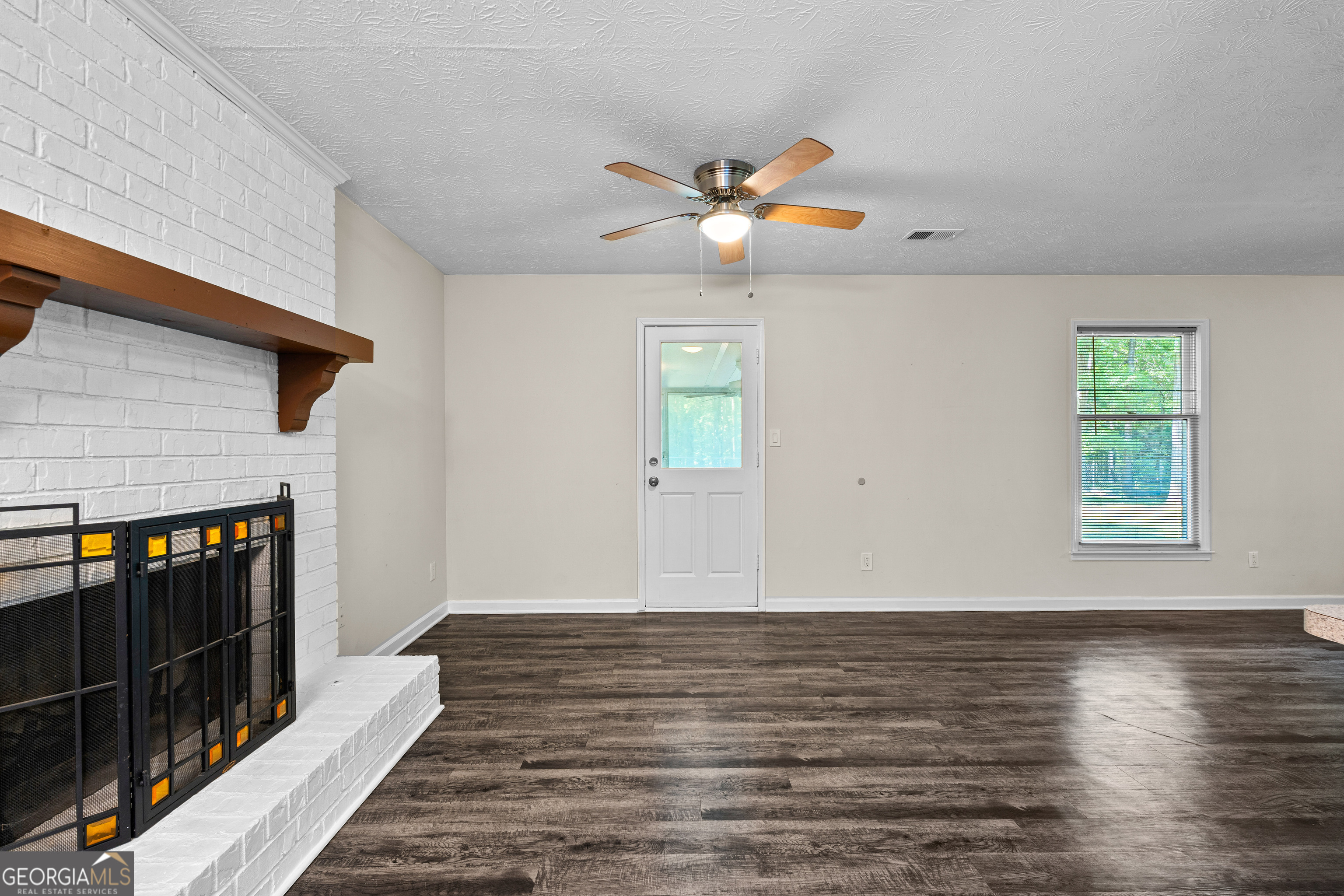 230 Ridge Road Tyrone, GA 30290 - Photo 11 of 47 a view of a livingroom with wooden floor and a ceiling fan