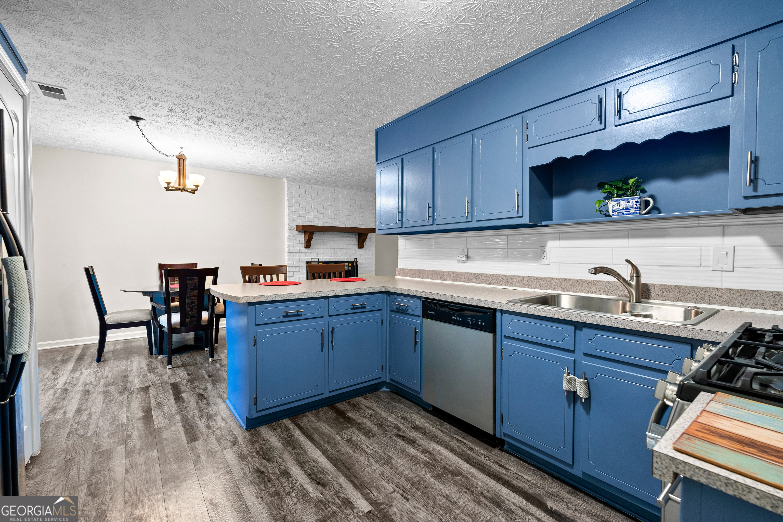 230 Ridge Road Tyrone, GA 30290 - Photo 16 of 47 a kitchen with wooden floors and wooden cabinets