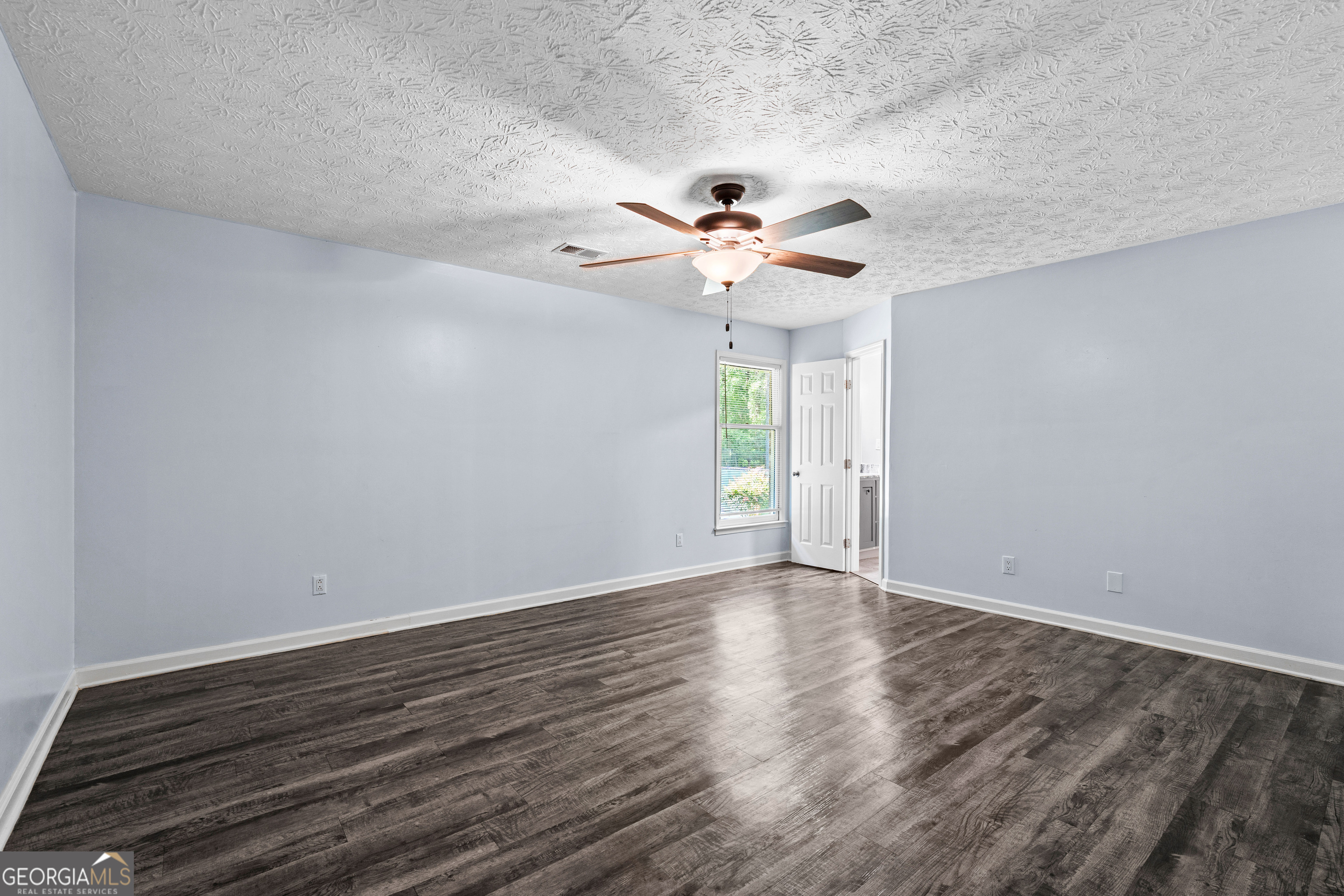 230 Ridge Road Tyrone, GA 30290 - Photo 19 of 47 a view of an empty room with window and wooden floor