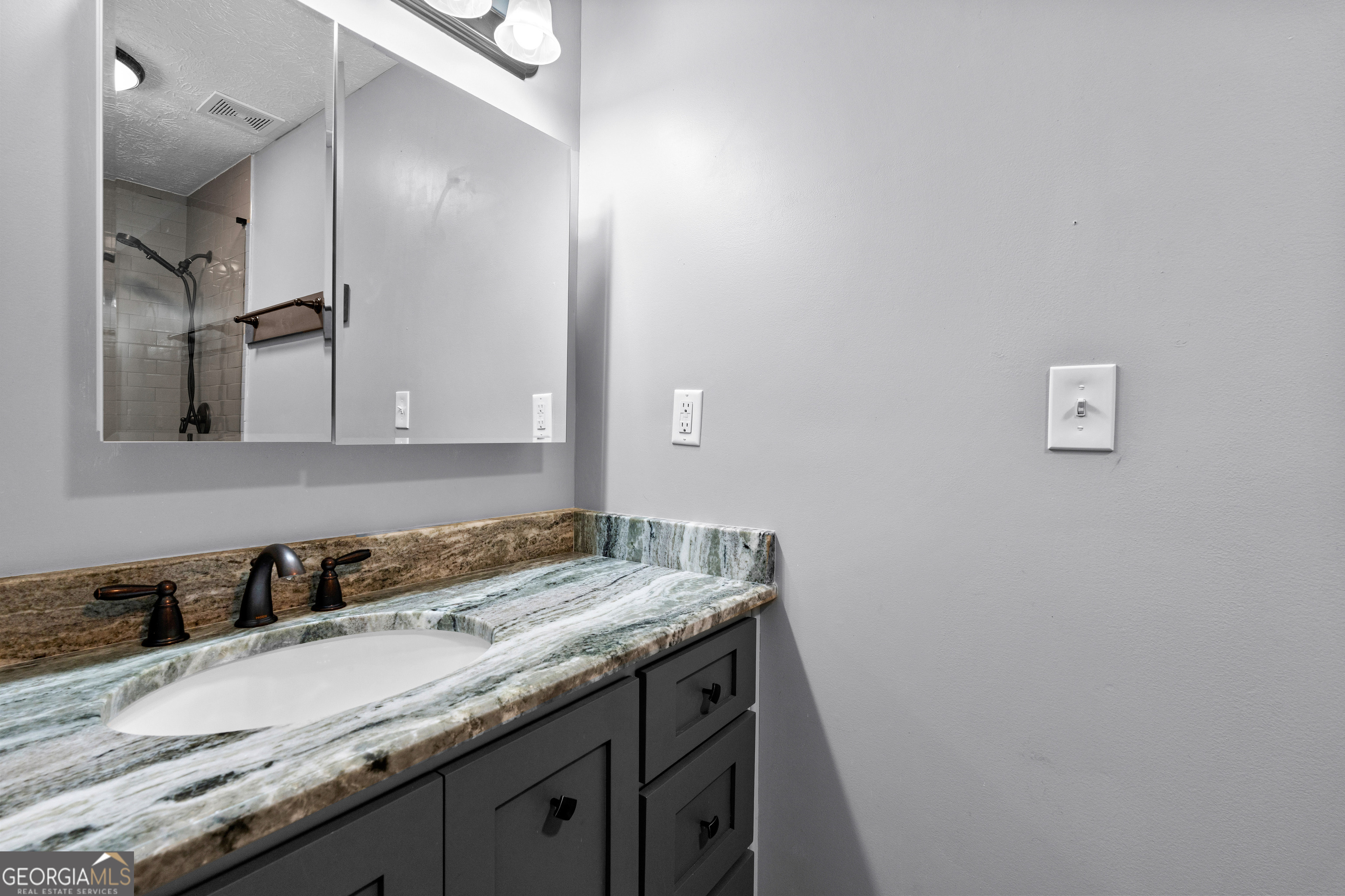 230 Ridge Road Tyrone, GA 30290 - Photo 22 of 47 a bathroom with a granite countertop sink and a mirror