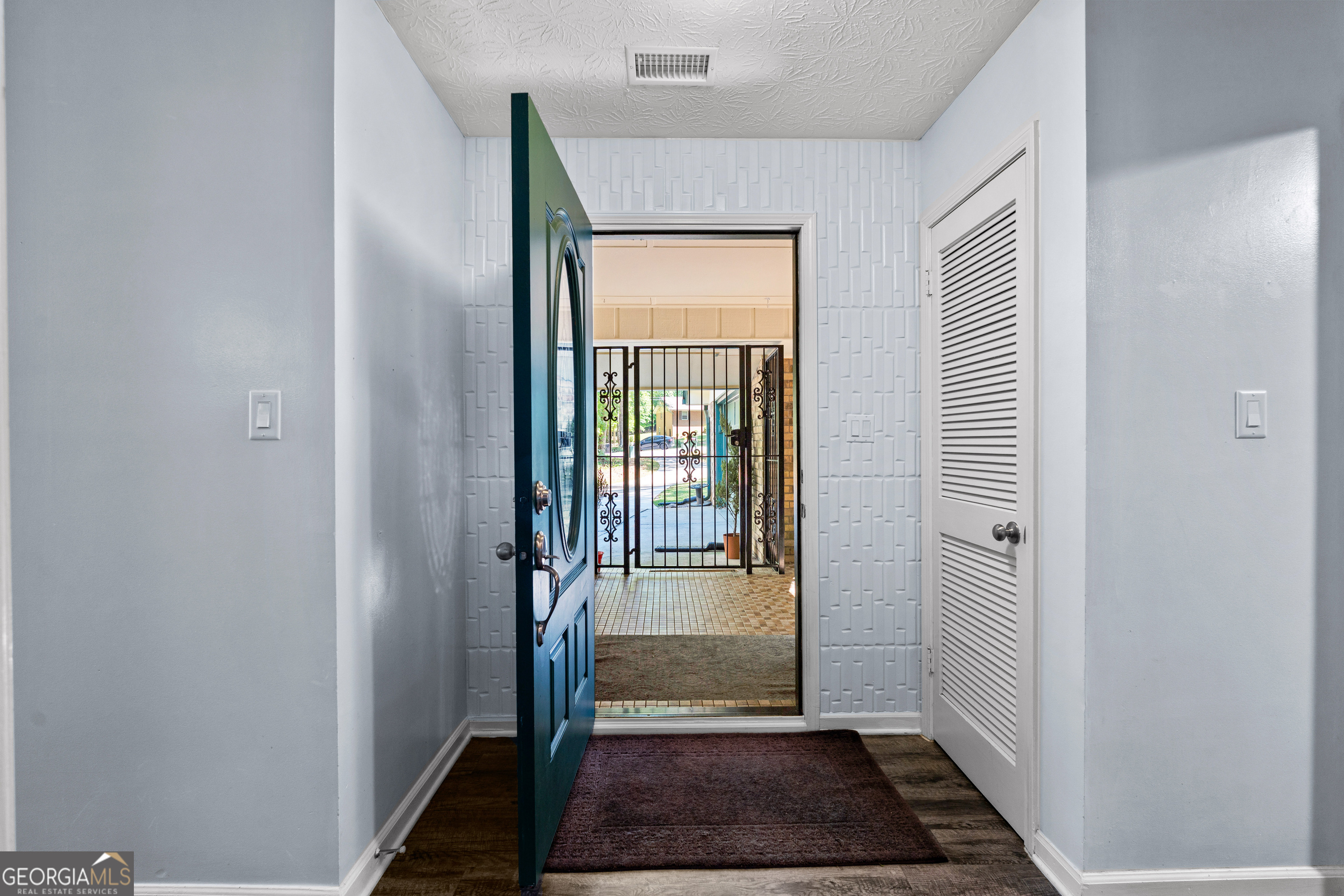 230 Ridge Road Tyrone, GA 30290 - Photo 4 of 47 a view of a hallway with wooden floor and a living room
