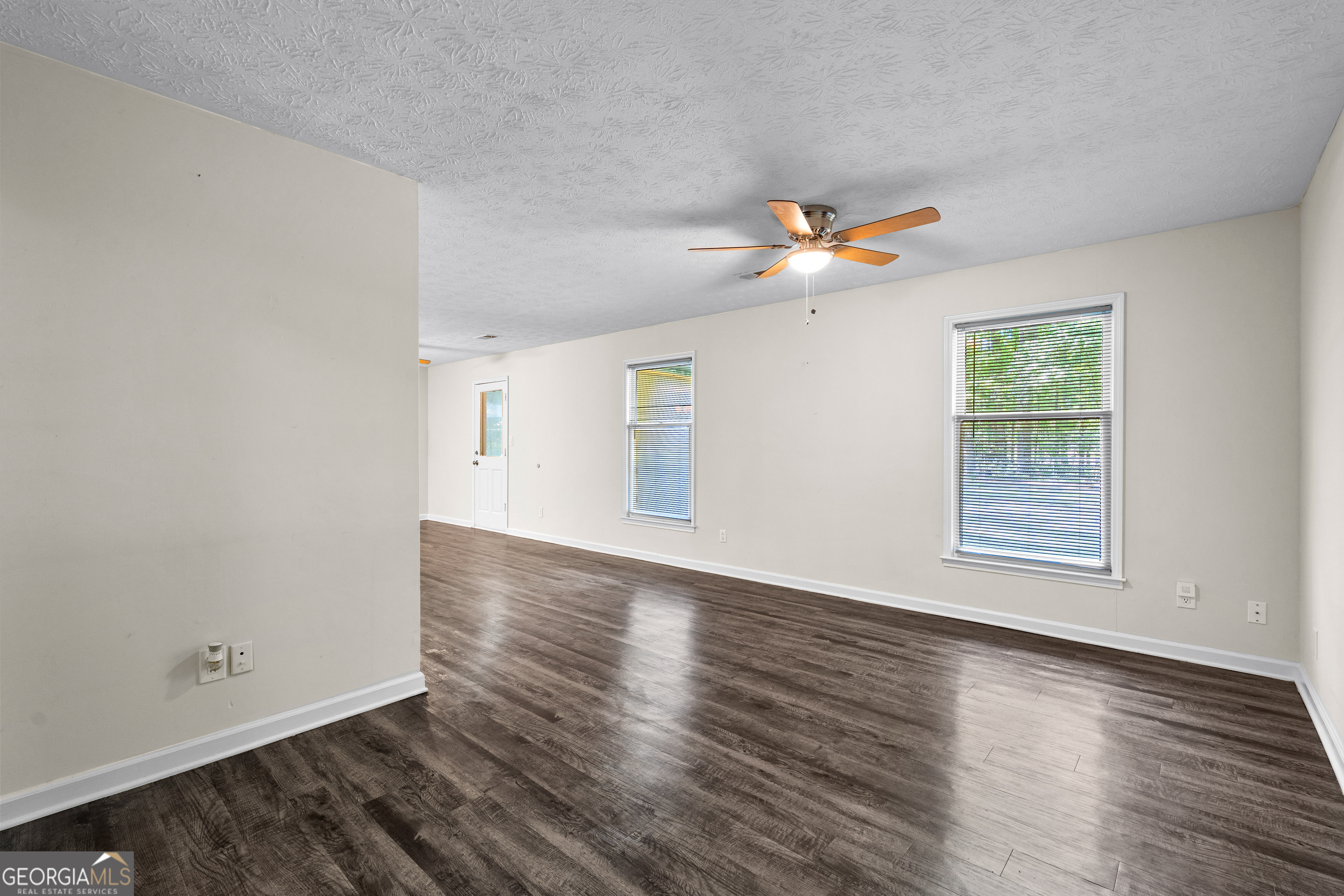 230 Ridge Road Tyrone, GA 30290 - Photo 7 of 47 a view of an empty room with wooden floor and a window