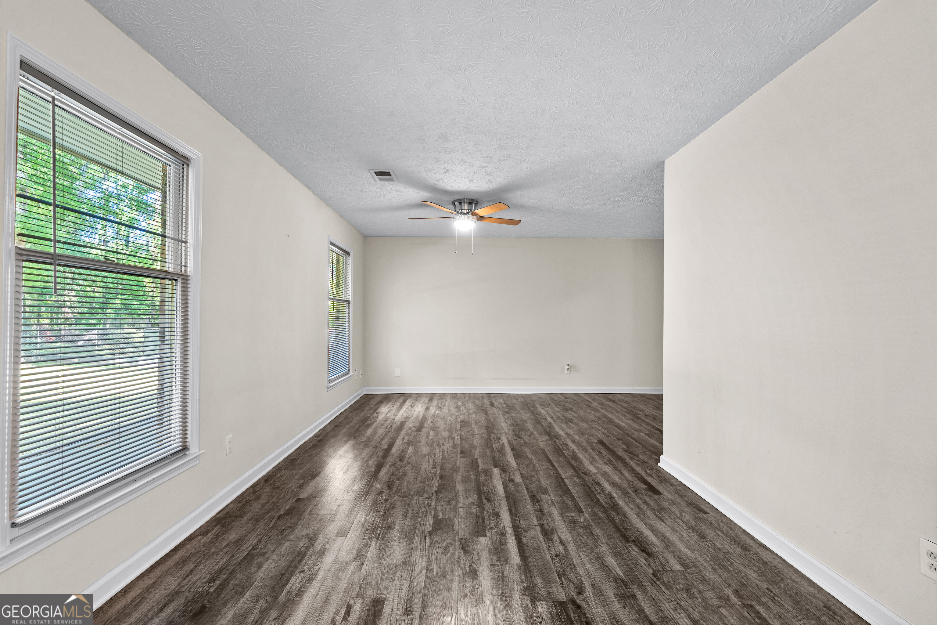 230 Ridge Road Tyrone, GA 30290 - Photo 9 of 47 a view of an empty room with wooden floor and a window