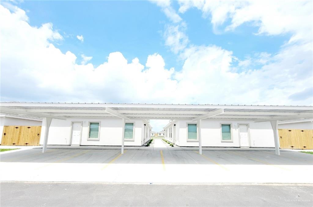 a view of white house with a flat screen tv and outdoor space