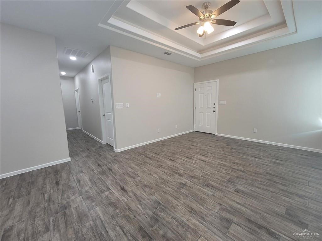 5901 Swallow Avenue, Unit 2 Mission, TX 78573 - Photo 6 of 11 wooden floor in an empty room with a window