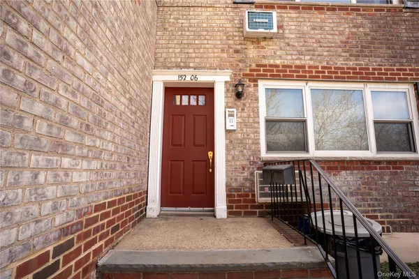 a view of wooden door and brick wall