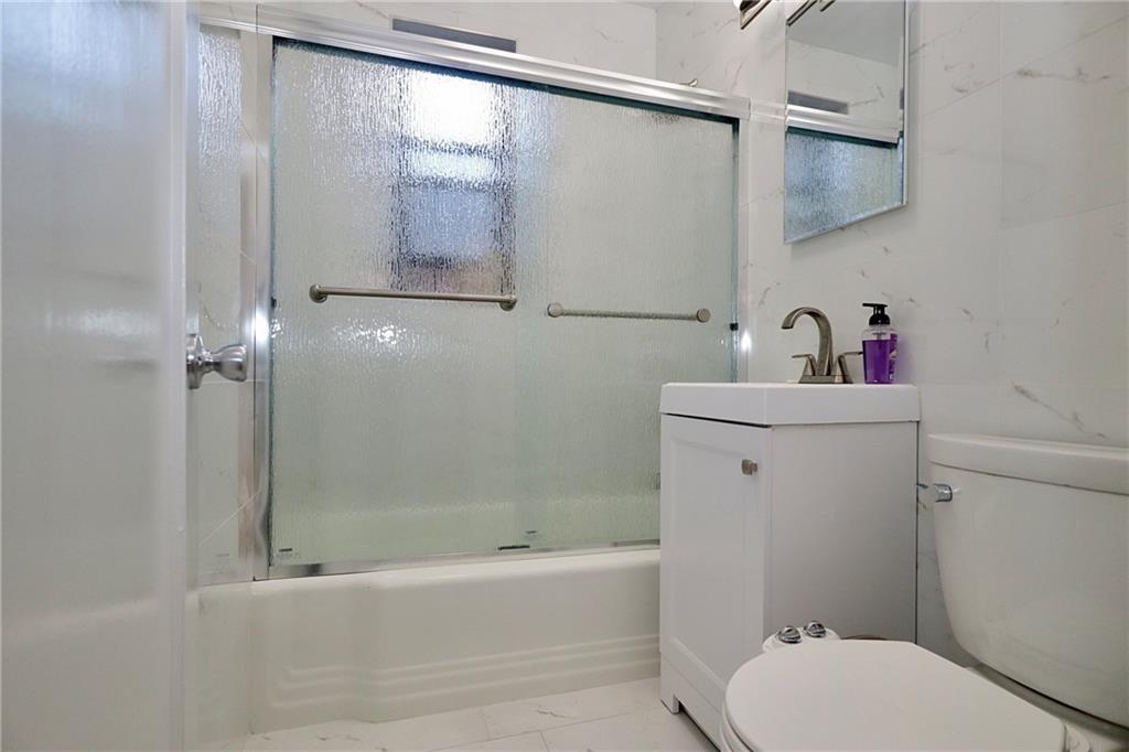 3025 Ocean Avenue, Unit 6E Brooklyn, NY 11235 - Photo 11 of 18 a bathroom with a sink toilet and shower