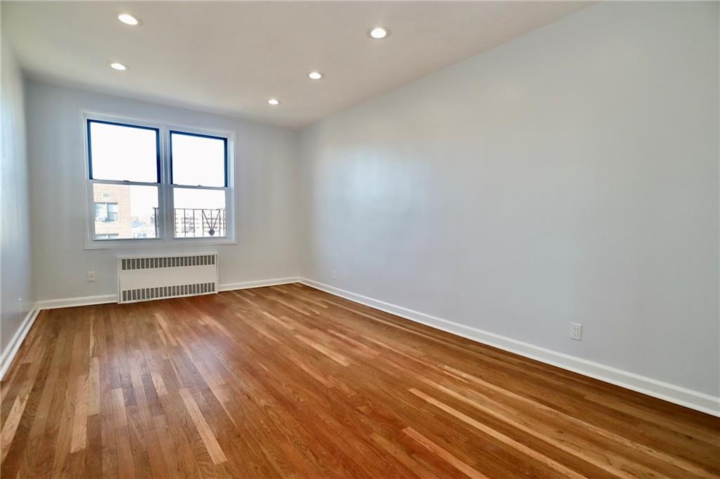 3025 Ocean Avenue, Unit 6E Brooklyn, NY 11235 - Photo 2 of 18 wooden floor in an empty room with a window