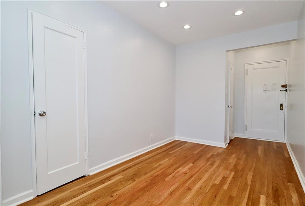3025 Ocean Avenue, Unit 6E Brooklyn, NY 11235 - Photo 3 of 18 a view of a room with wooden floor and white walls