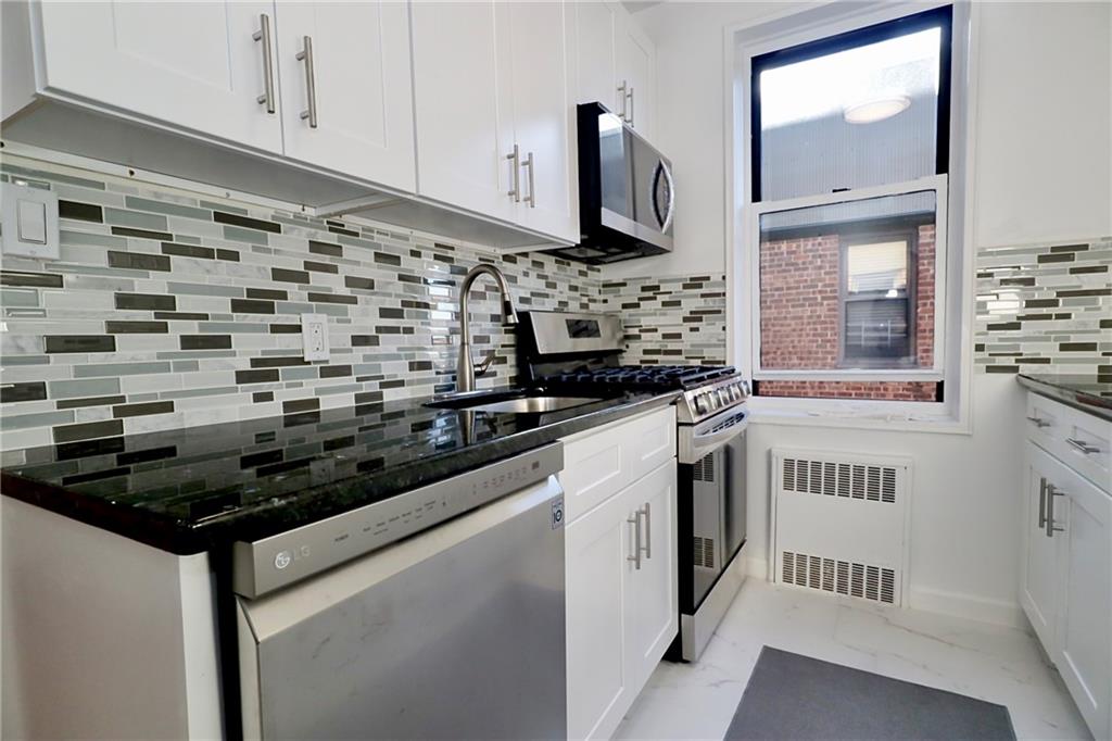3025 Ocean Avenue, Unit 6E Brooklyn, NY 11235 - Photo 7 of 18 a kitchen with a stove and a microwave