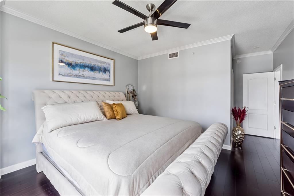 3475 Oak Valley Road Northeast, Unit 980 Atlanta, GA 30326 - Photo 20 of 42 a bedroom with a bed and a chandelier