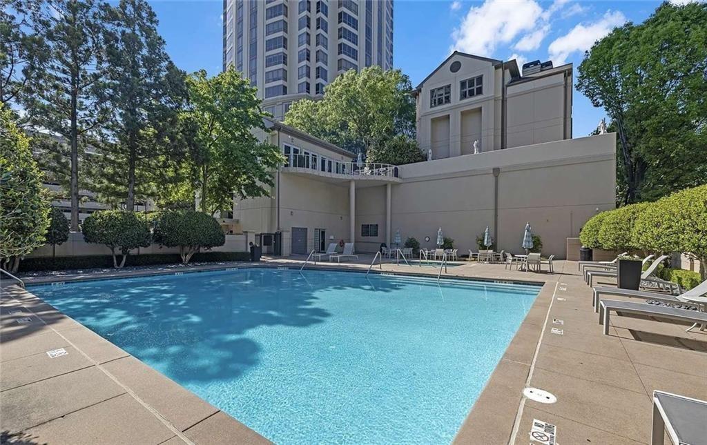 3475 Oak Valley Road Northeast, Unit 980 Atlanta, GA 30326 - Photo 26 of 42 a view of a swimming pool with a patio