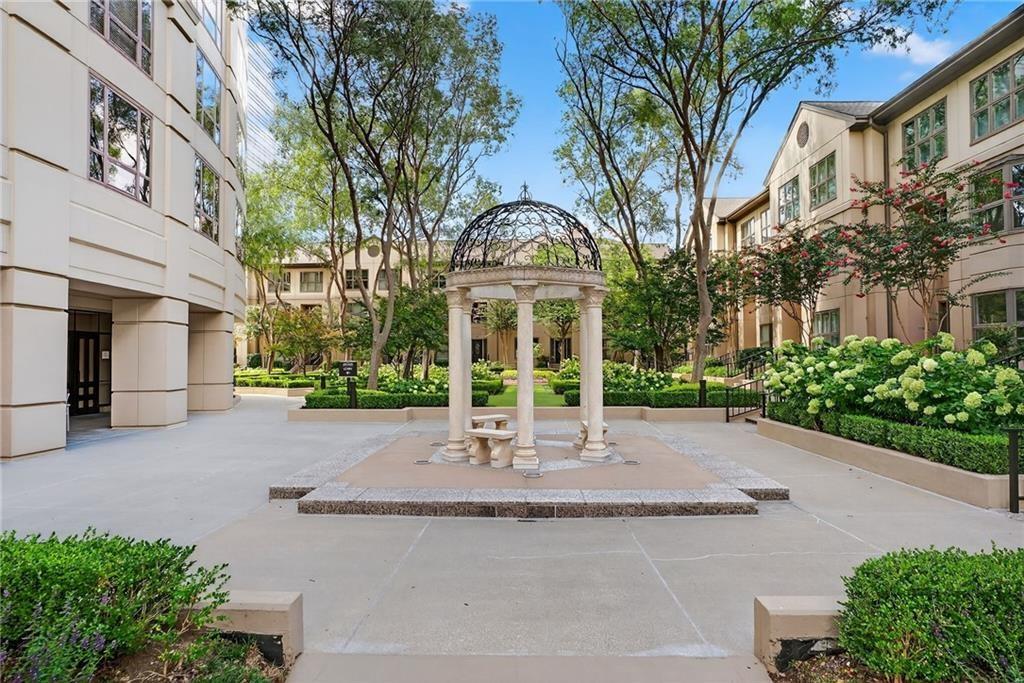 3475 Oak Valley Road Northeast, Unit 980 Atlanta, GA 30326 - Photo 30 of 42 a view of a white house with large windows and a table and chairs in porch