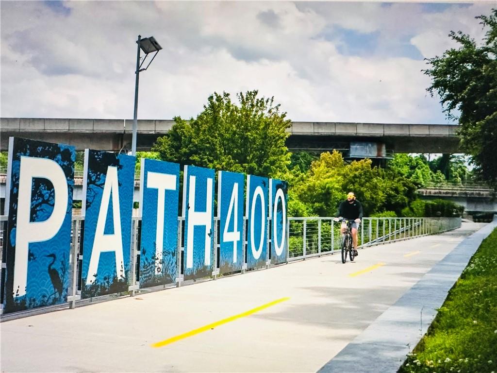 3475 Oak Valley Road Northeast, Unit 980 Atlanta, GA 30326 - Photo 41 of 42 a view of a house with a porch next to a road
