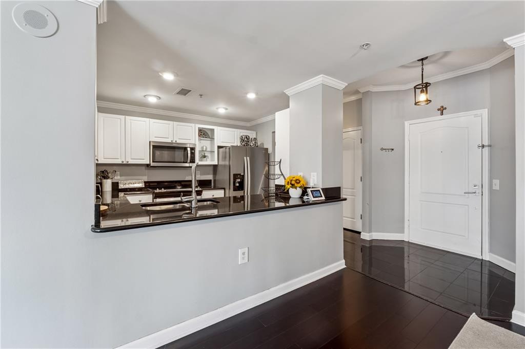 3475 Oak Valley Road Northeast, Unit 980 Atlanta, GA 30326 - Photo 6 of 42 a kitchen with stainless steel appliances a refrigerator and a stove top oven