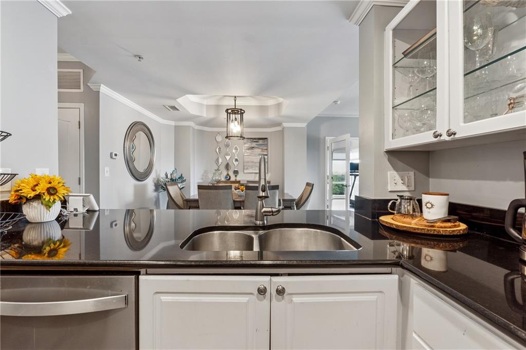 3475 Oak Valley Road Northeast, Unit 980 Atlanta, GA 30326 - Photo 9 of 42 a kitchen with a sink and a clock on the wall
