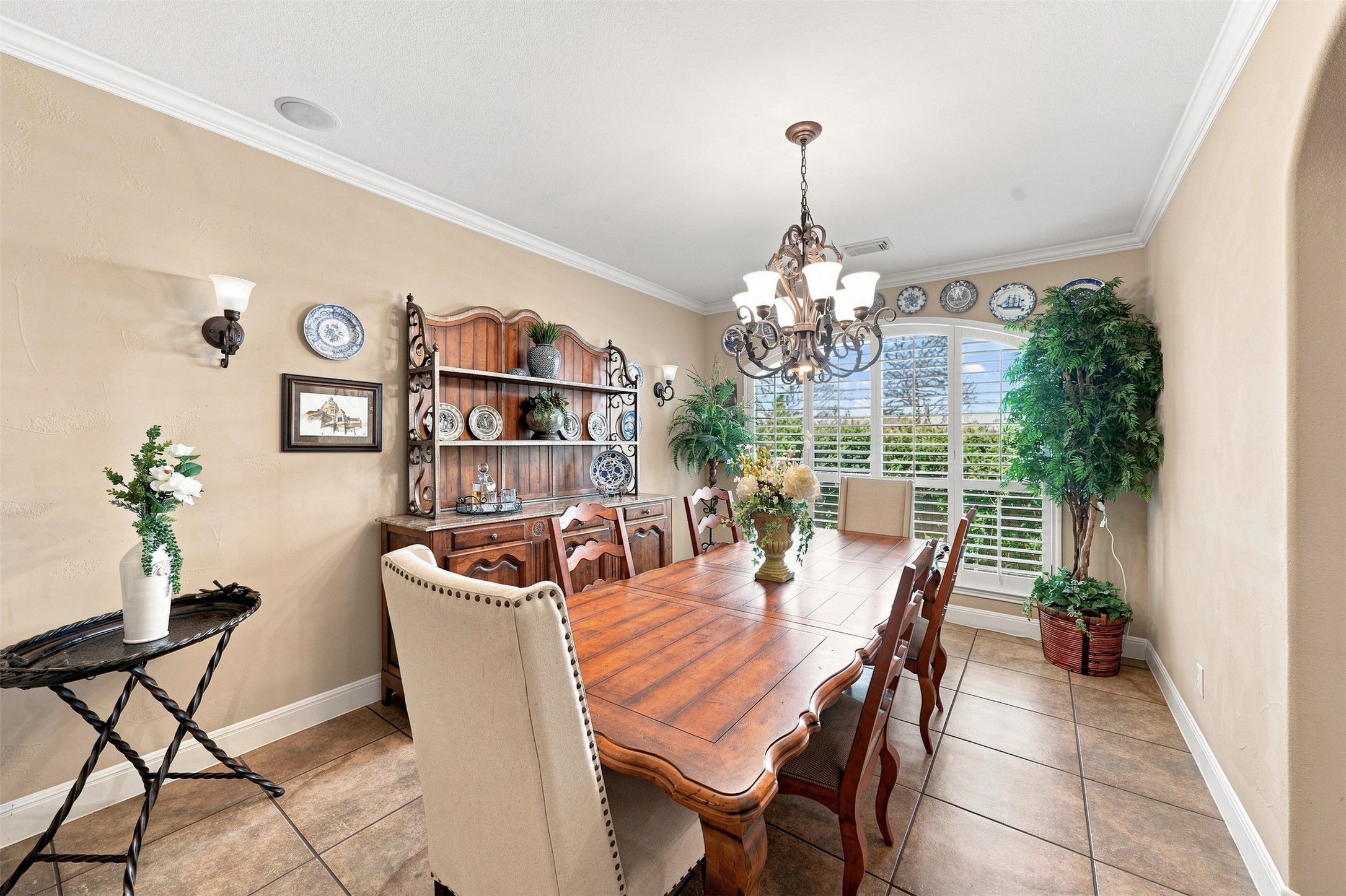 402 Ridgetop Bend Cedar Park, TX 78613 - Photo 20 of 40 Elegant dining space featuring timeless tile flooring, crown molding, and plantation shutters.