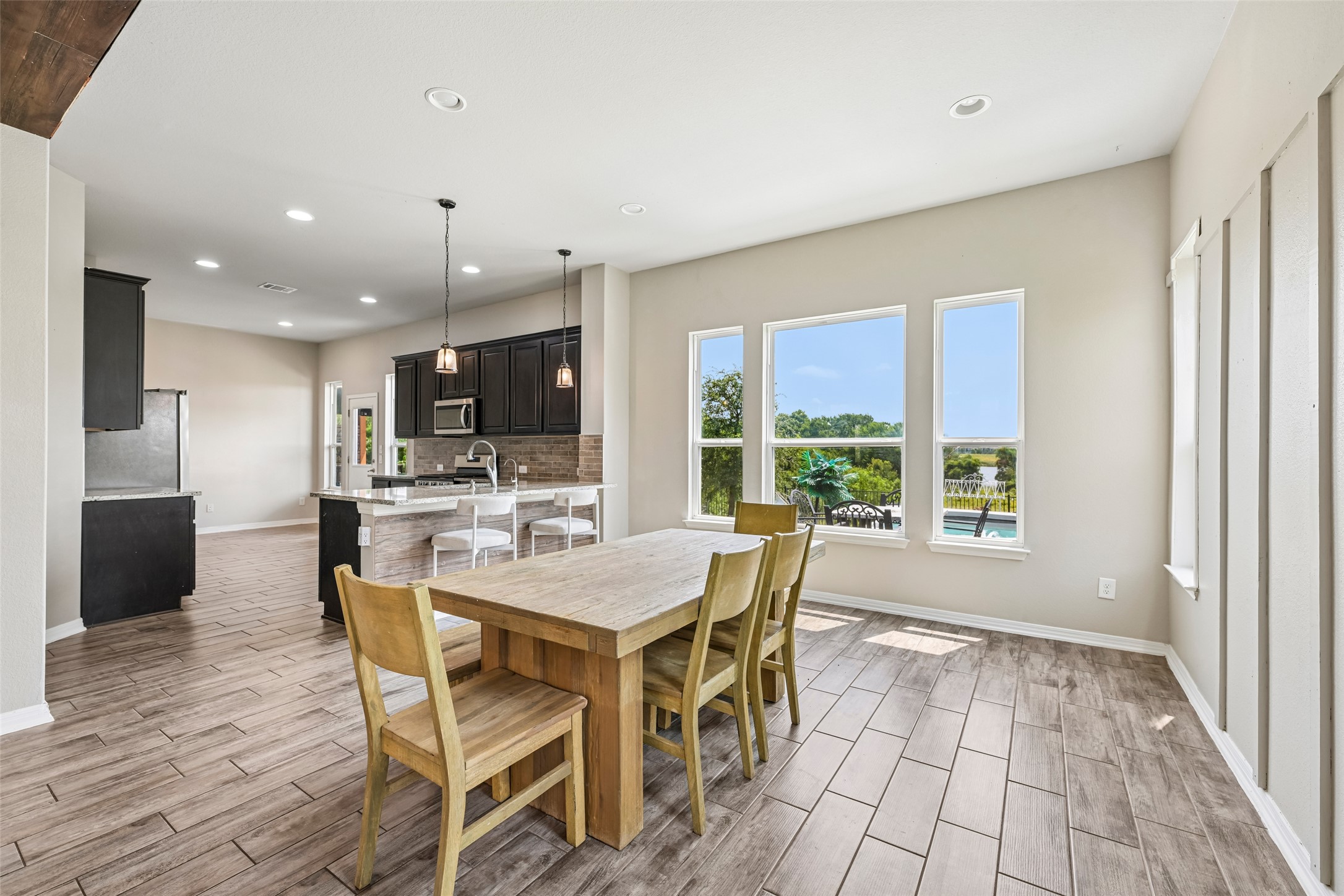 1297 Harwell Loop Kyle, TX 78640 - Photo 13 of 39 An open-concept living space integrates a well-appointed kitchen and dining area with abundant natural light.