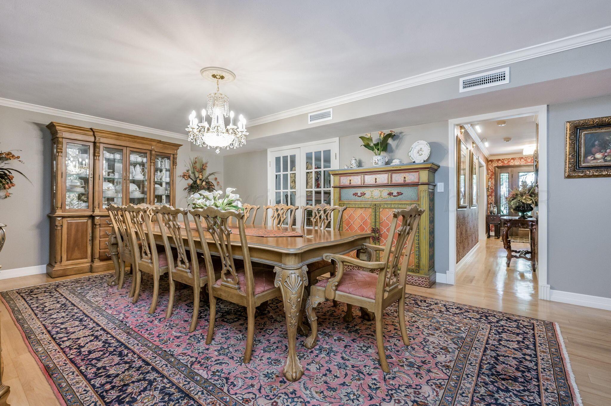 3518 Danbury Drive Amarillo, TX 79109 - Photo 21 of 59 a dining room with furniture a rug and a chandelier