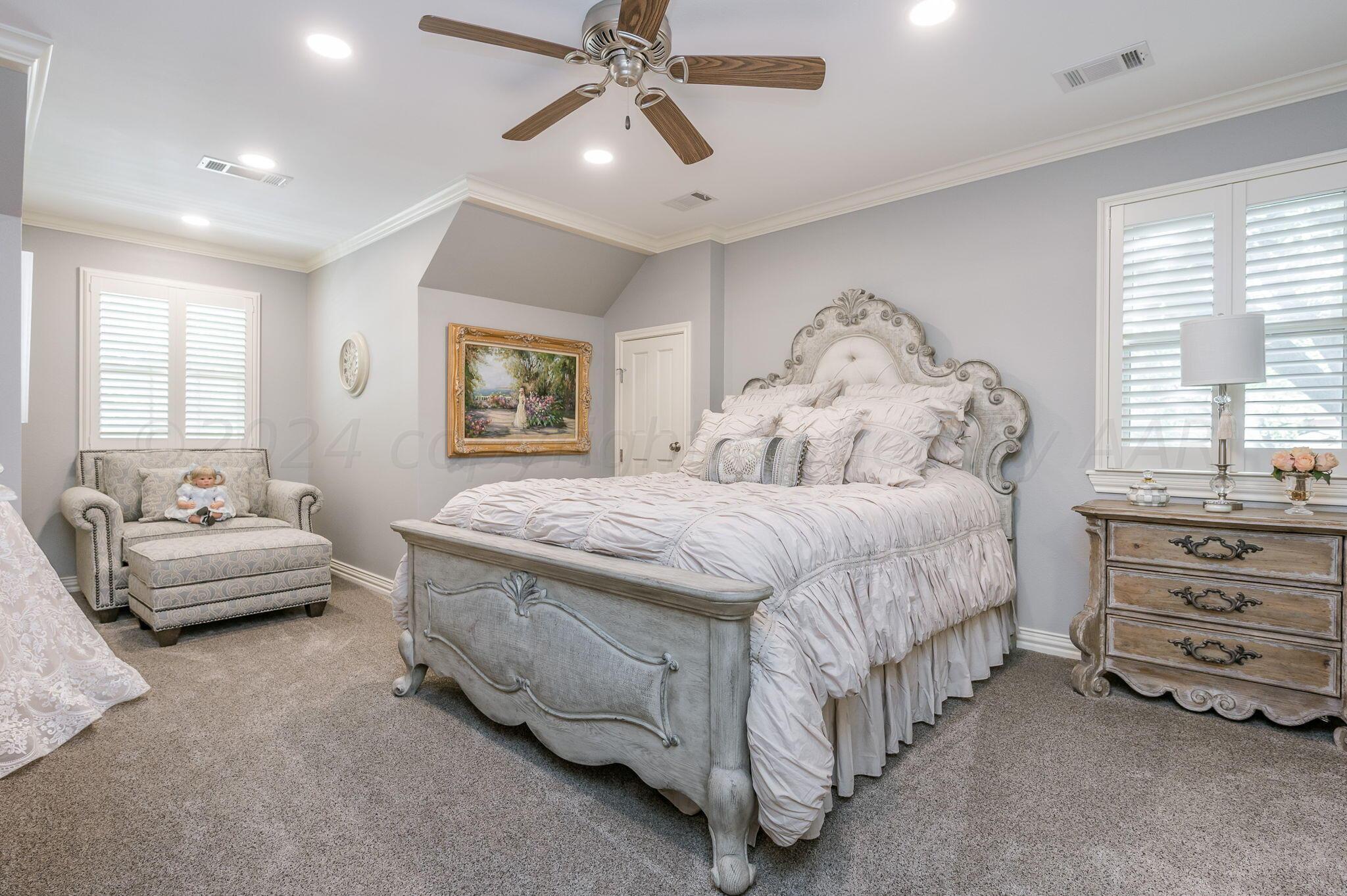 3518 Danbury Drive Amarillo, TX 79109 - Photo 27 of 59 a spacious bedroom with a bed and a couch