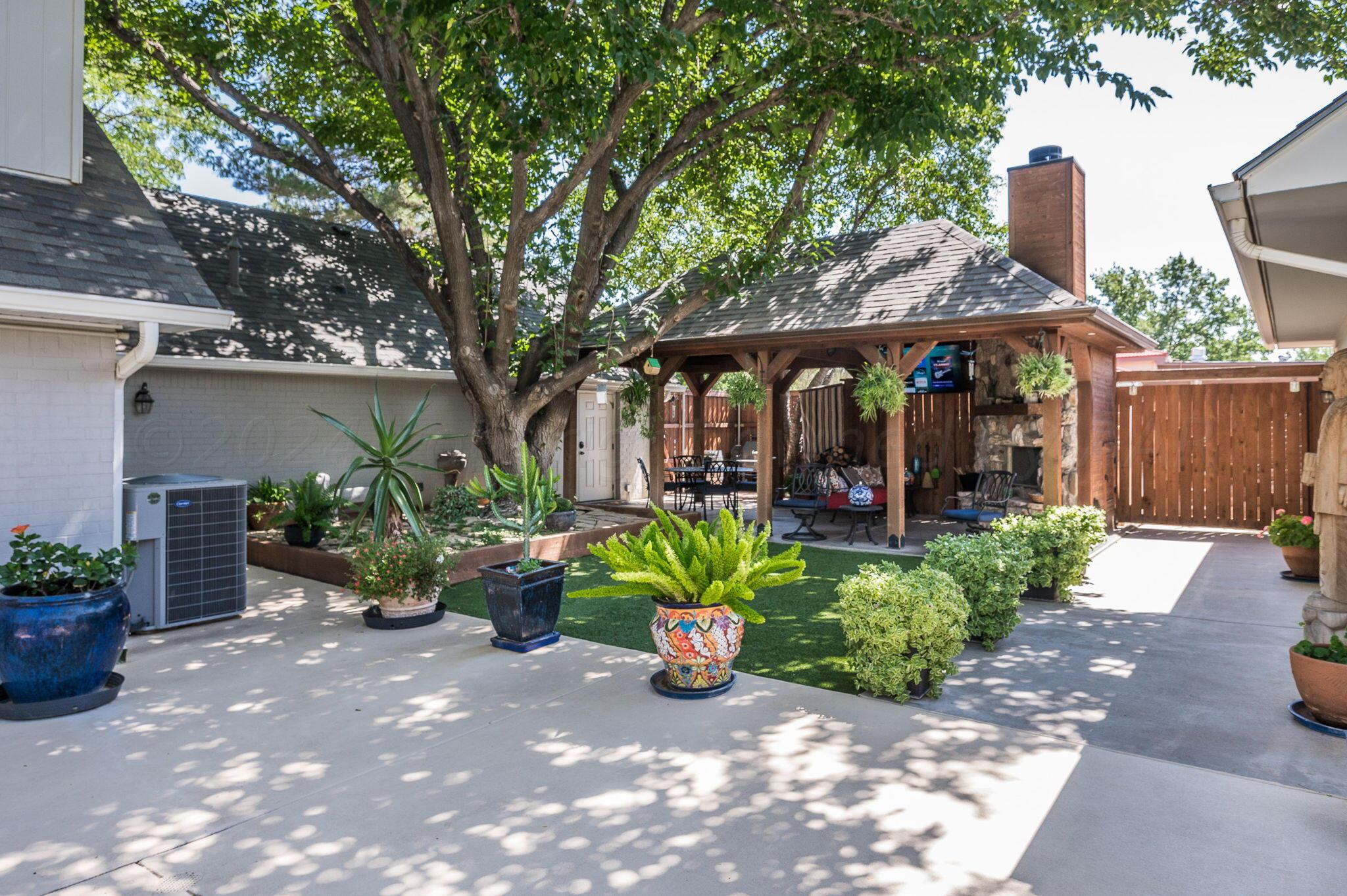3518 Danbury Drive Amarillo, TX 79109 - Photo 51 of 59 a view of a patio with table and chairs potted plants and large tree
