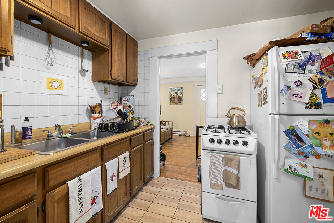 2105 Echo Park Avenue Los Angeles, CA 90026 - Photo 17 of 31 a kitchen with stainless steel appliances granite countertop a stove a sink and a microwave
