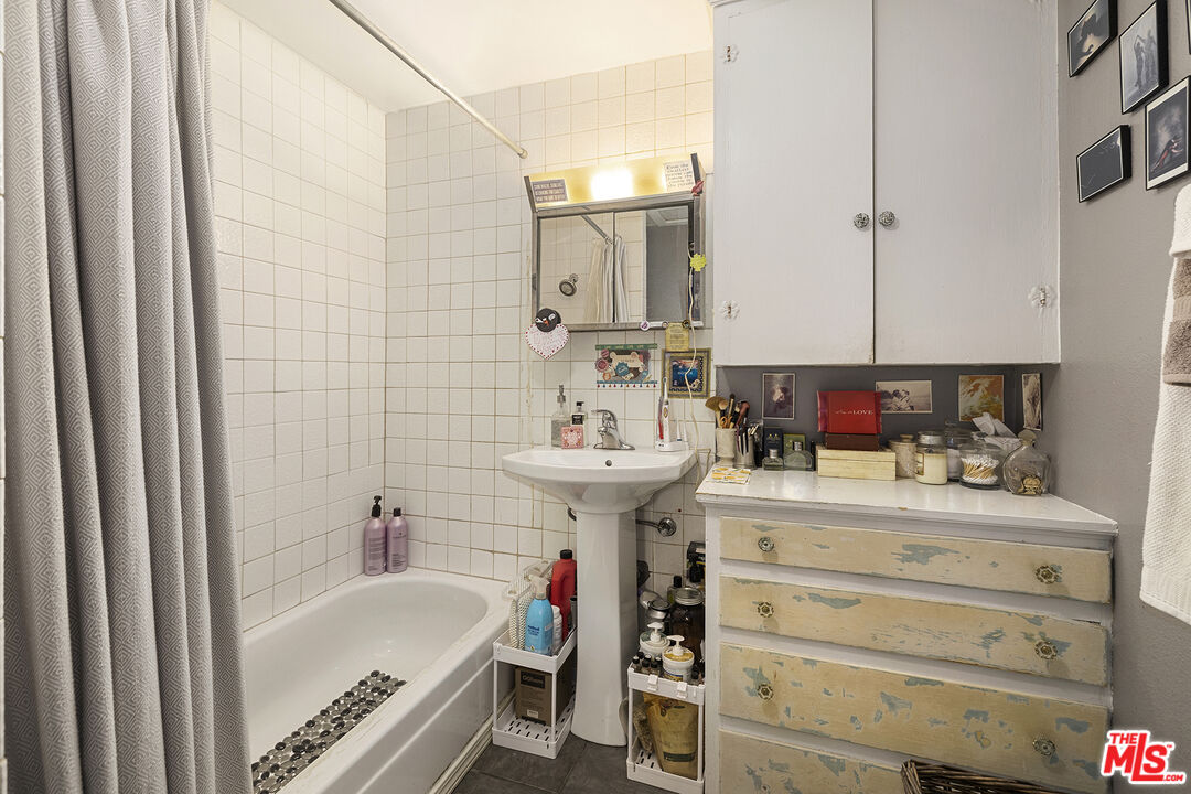 2105 Echo Park Avenue Los Angeles, CA 90026 - Photo 19 of 31 a bathroom with a sink a bathtub and a mirror