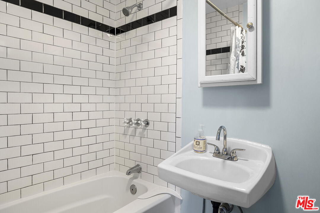 2105 Echo Park Avenue Los Angeles, CA 90026 - Photo 22 of 31 a bathroom with a sink a toilet and shower