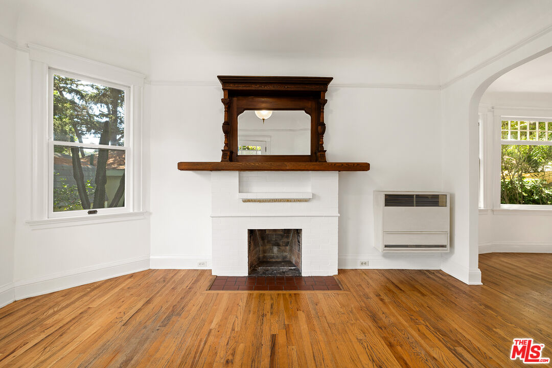 2105 Echo Park Avenue Los Angeles, CA 90026 - Photo 5 of 31 a view of empty room with a fireplace and wooden floor