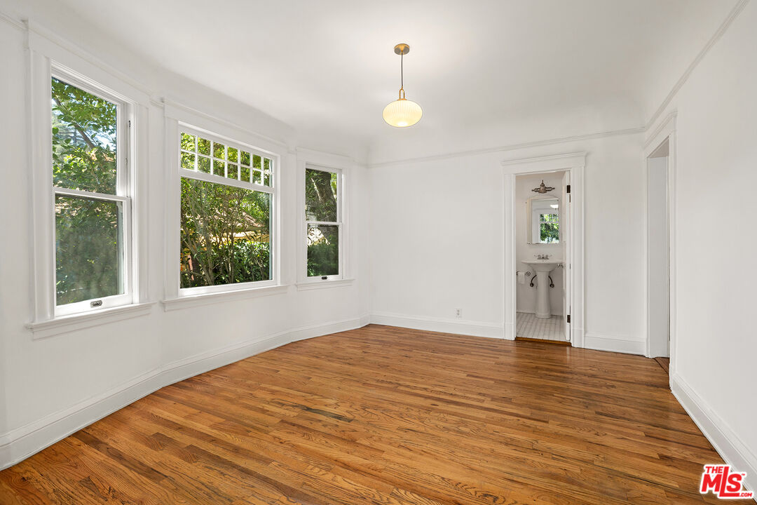 2105 Echo Park Avenue Los Angeles, CA 90026 - Photo 7 of 31 a view of an empty room with wooden floor and a window