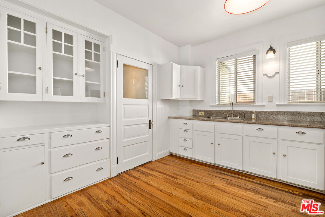 2105 Echo Park Avenue Los Angeles, CA 90026 - Photo 8 of 31 a kitchen with granite countertop white cabinets and window