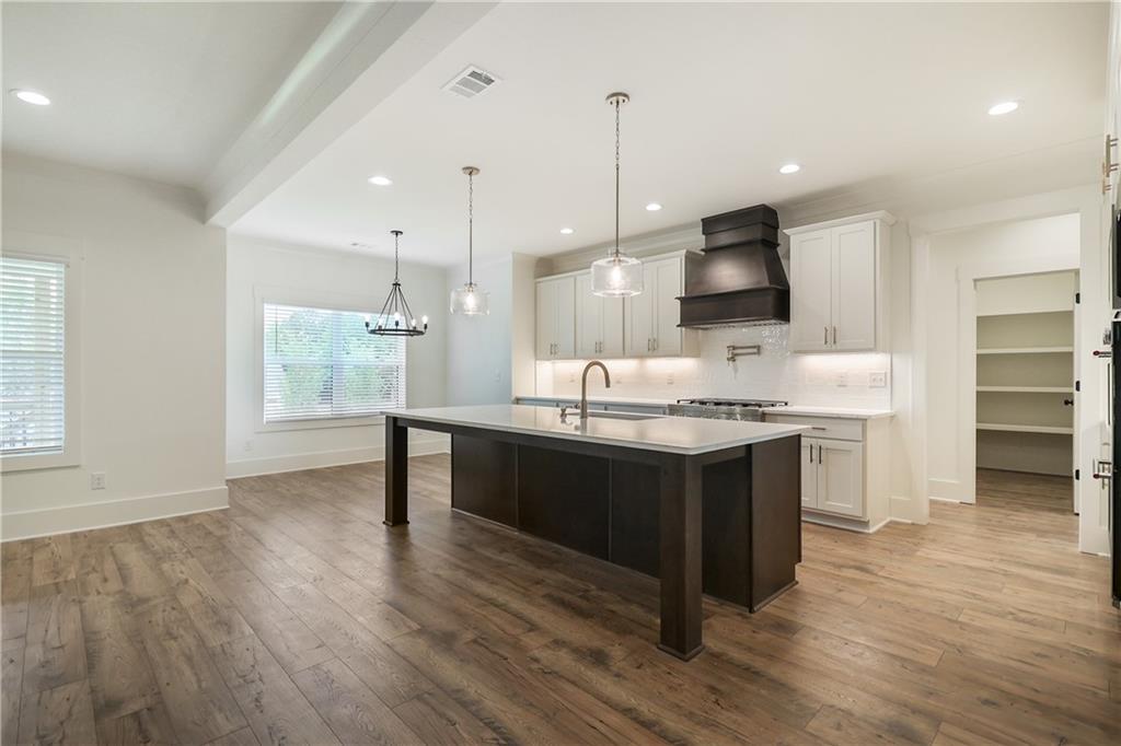 2113 Stonegate Way Monroe, GA 30656 - Photo 15 of 43 a kitchen with kitchen island granite countertop a sink appliances and cabinets