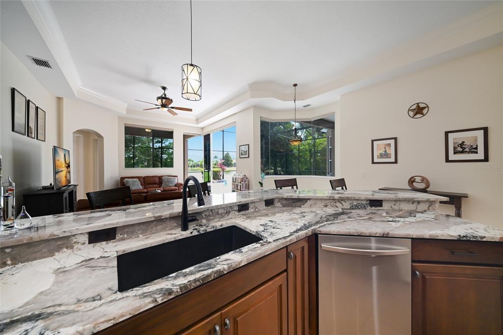 14806 Bowfin Terrace Lakewood Ranch, FL 34202 - Photo 21 of 58 a kitchen with a sink and a refrigerator
