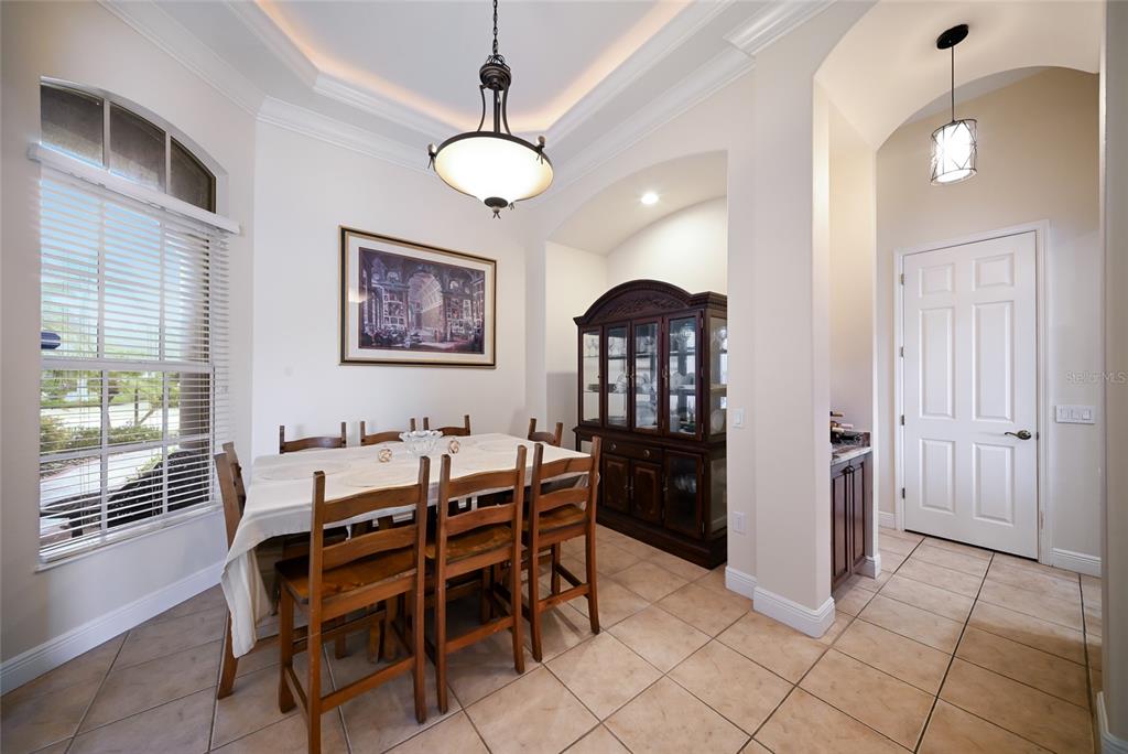 14806 Bowfin Terrace Lakewood Ranch, FL 34202 - Photo 23 of 58 a dining room with furniture and window