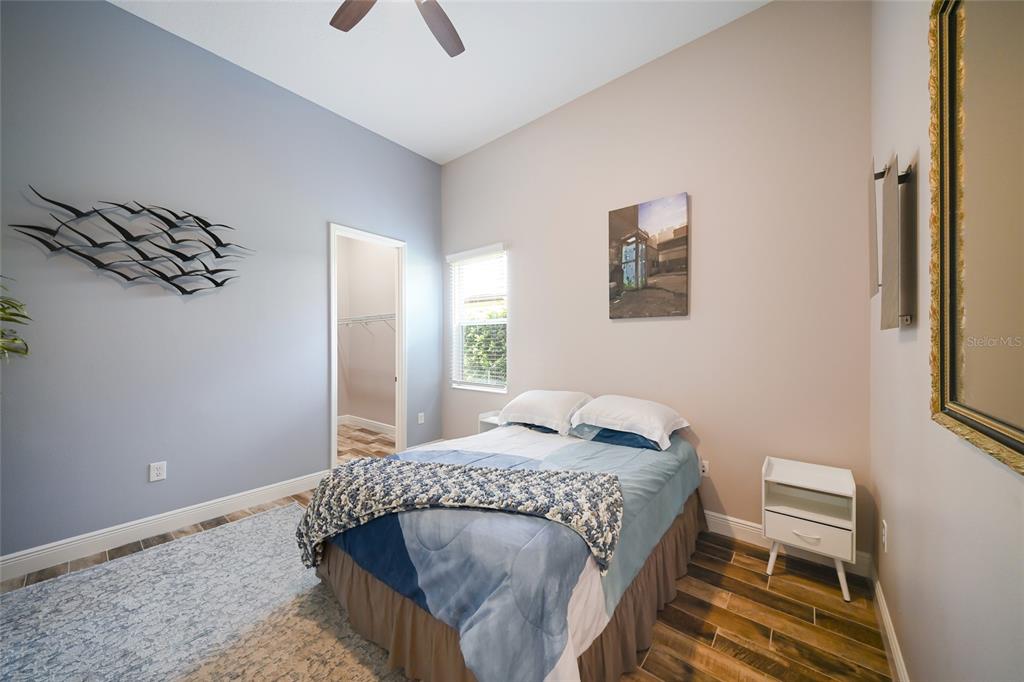 14806 Bowfin Terrace Lakewood Ranch, FL 34202 - Photo 25 of 58 a bedroom with a bed and wooden floor