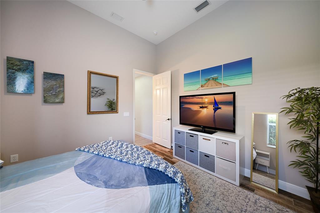 14806 Bowfin Terrace Lakewood Ranch, FL 34202 - Photo 26 of 58 a bedroom with a bed and a flat screen tv