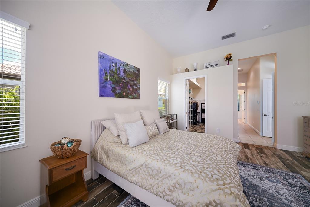 14806 Bowfin Terrace Lakewood Ranch, FL 34202 - Photo 30 of 58 a bedroom with a large bed and a window