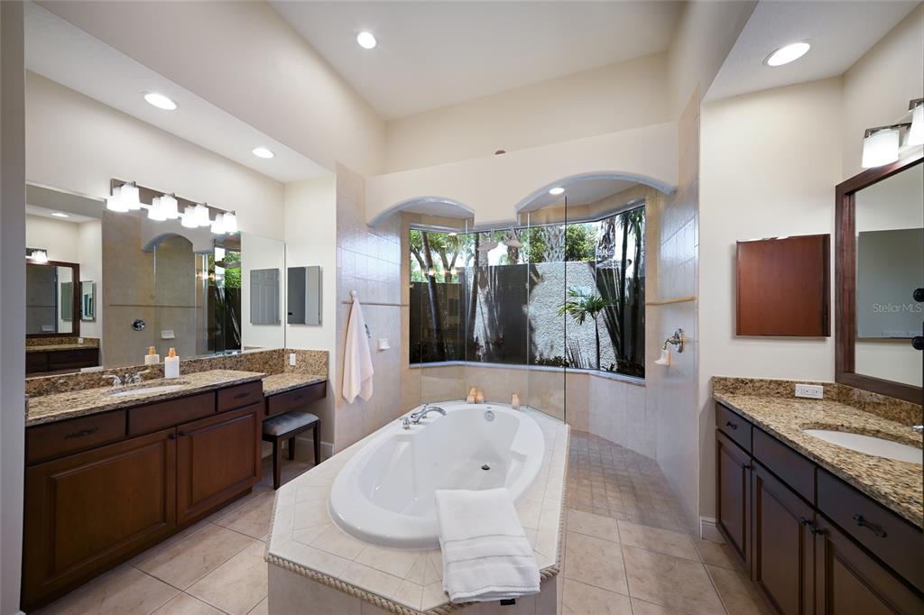 14806 Bowfin Terrace Lakewood Ranch, FL 34202 - Photo 32 of 58 a large bathroom with a large tub and sink