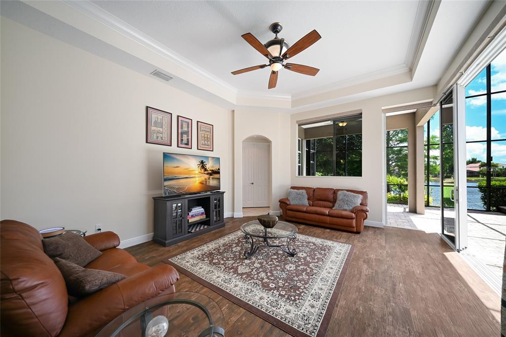 14806 Bowfin Terrace Lakewood Ranch, FL 34202 - Photo 35 of 58 a living room with furniture fireplace and flat screen tv