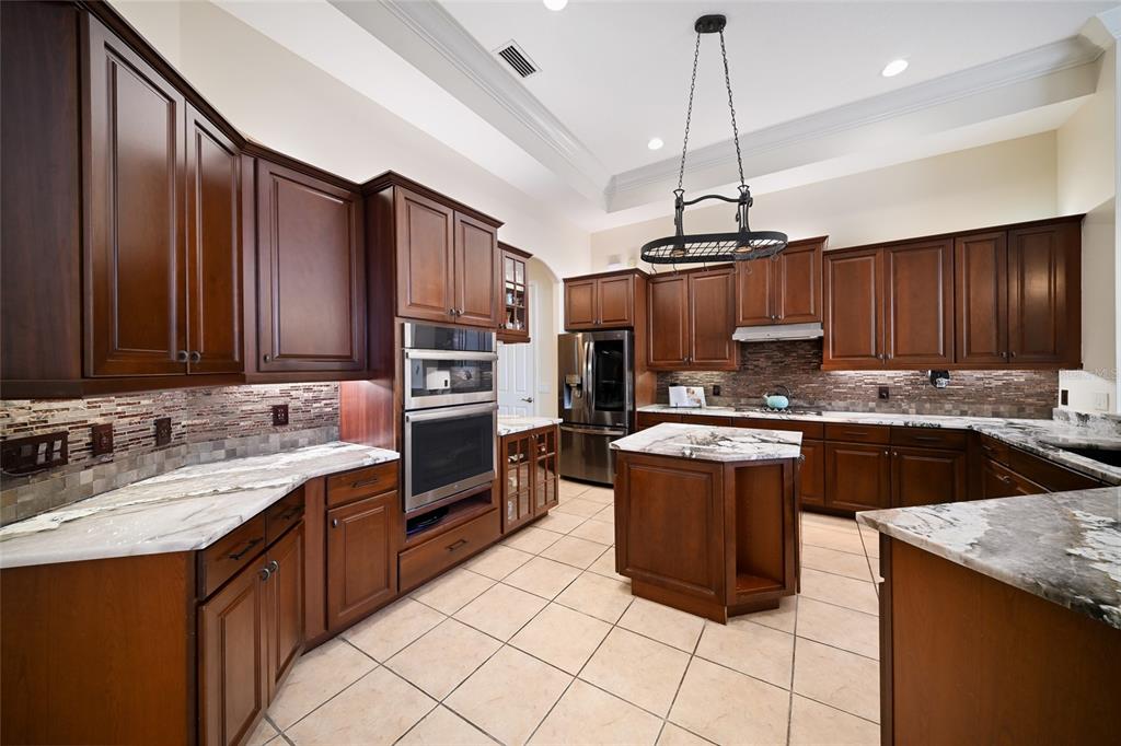 14806 Bowfin Terrace Lakewood Ranch, FL 34202 - Photo 4 of 58 a kitchen with a sink stove and refrigerator