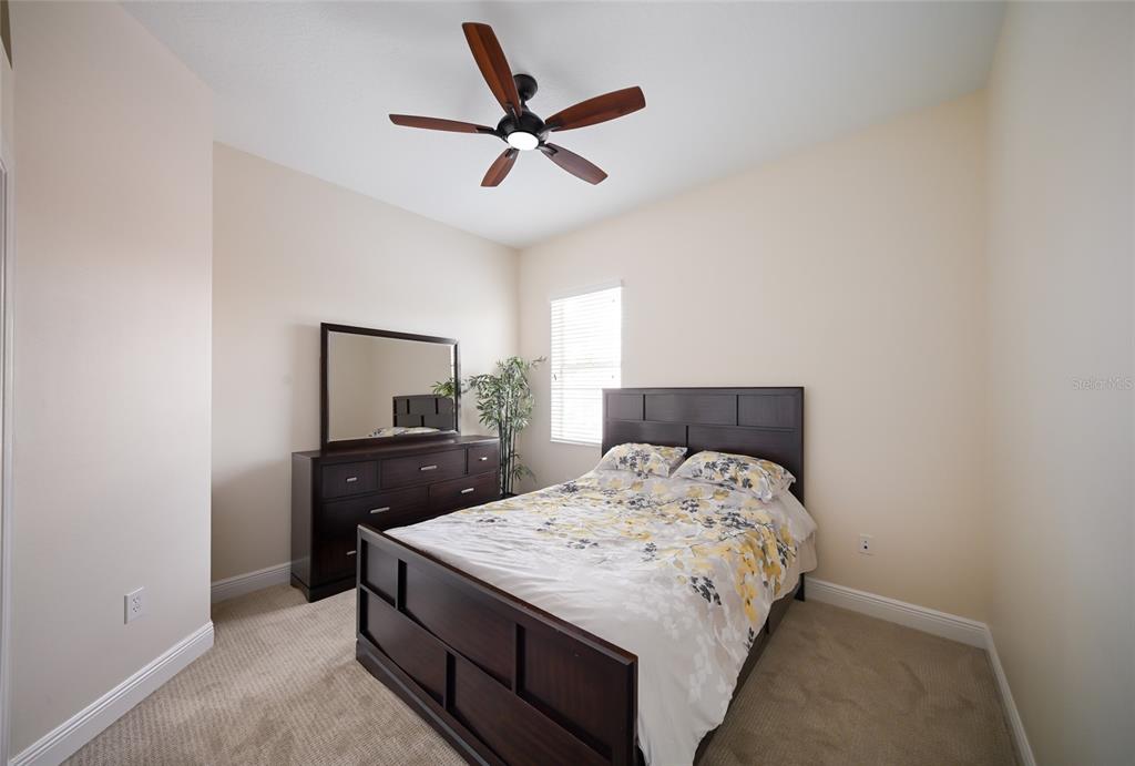14806 Bowfin Terrace Lakewood Ranch, FL 34202 - Photo 44 of 58 a bedroom with a bed and a dresser