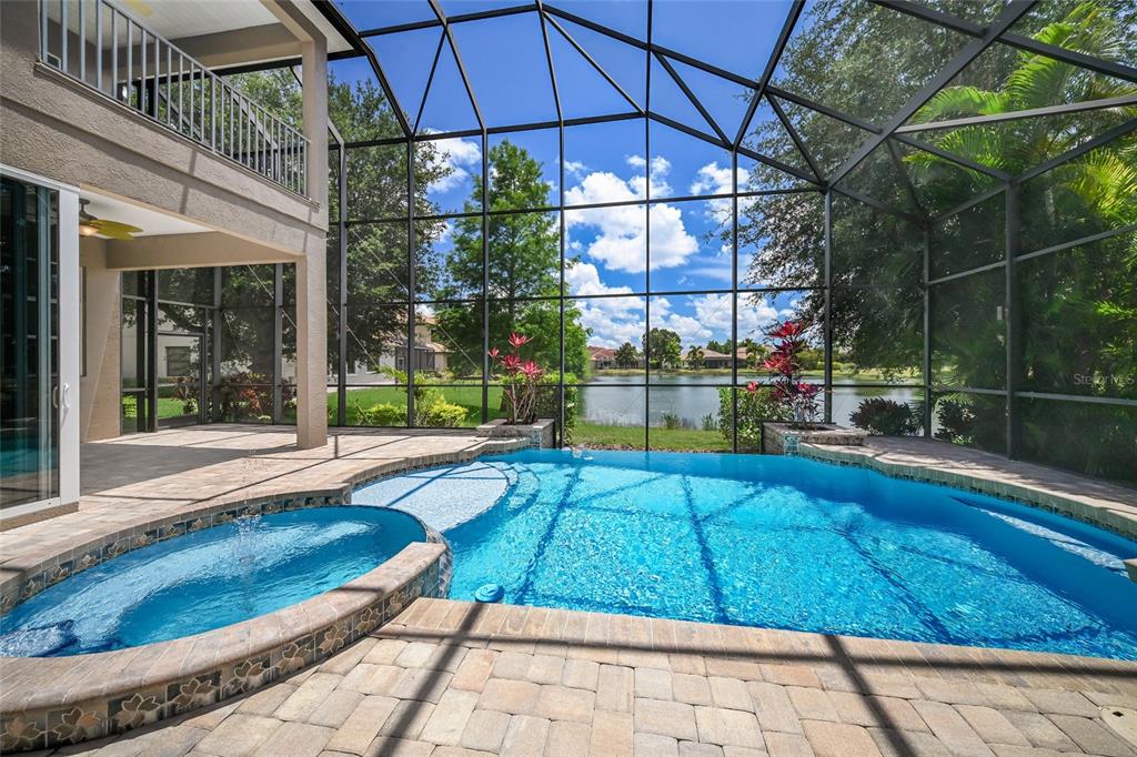 14806 Bowfin Terrace Lakewood Ranch, FL 34202 - Photo 50 of 58 a view of a swimming pool with a porch and furniture