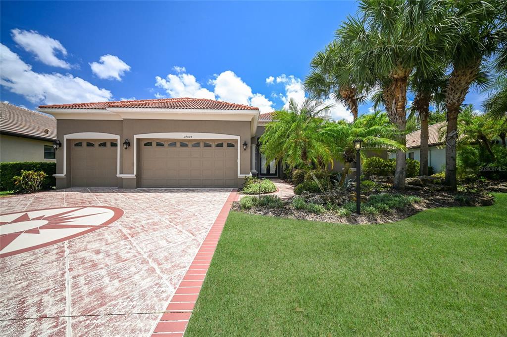 14806 Bowfin Terrace Lakewood Ranch, FL 34202 - Photo 54 of 58 a front view of a house with a garden and yard
