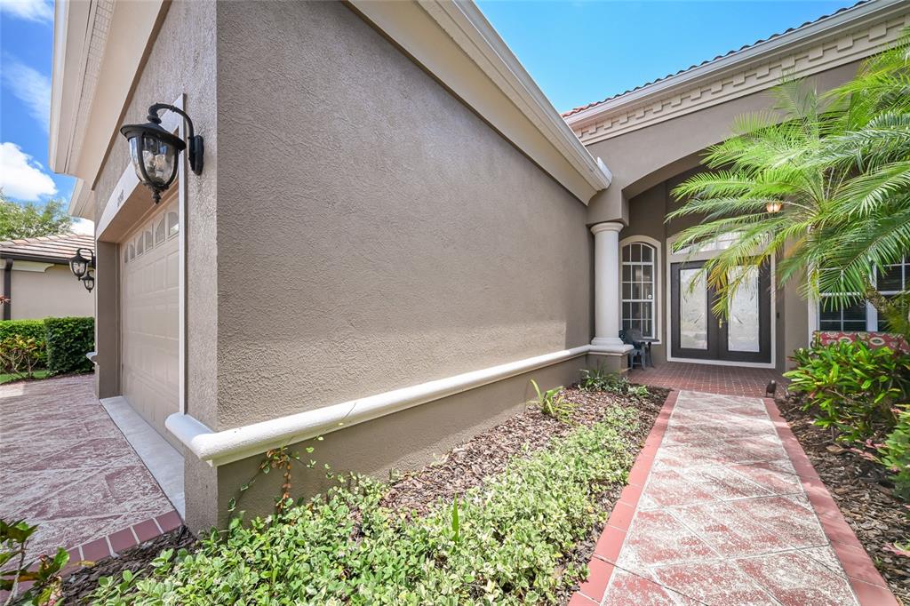 14806 Bowfin Terrace Lakewood Ranch, FL 34202 - Photo 8 of 58 a front view of a house with garden