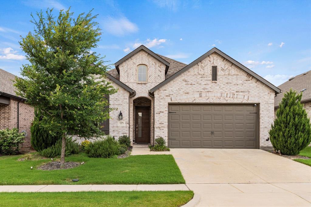 1317 Windflower Drive Aubrey, TX 76227 - Photo 1 of 1 a front view of a house with a yard and garage