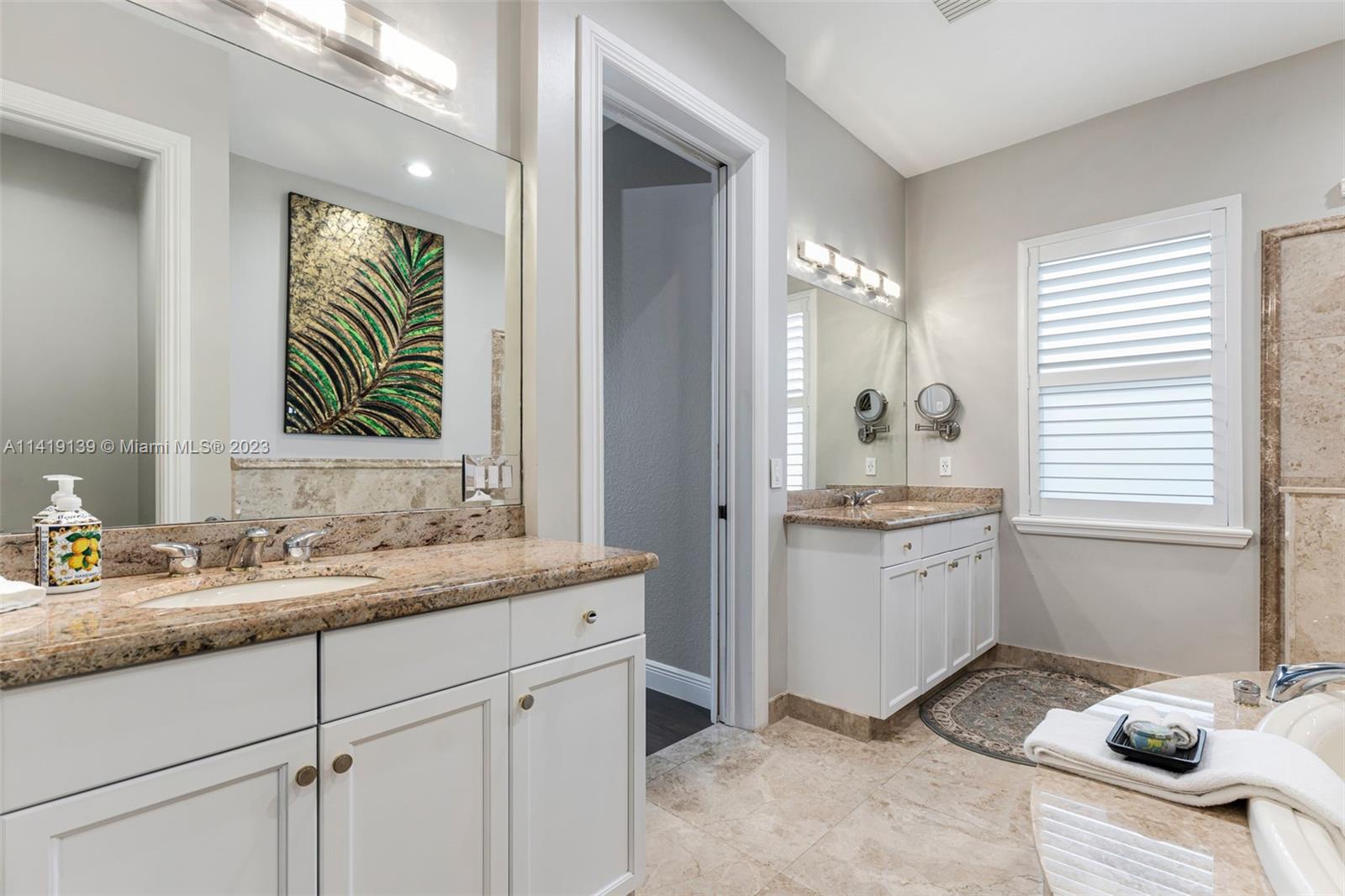 7982 Northwest 109th Lane Parkland, FL 33076 - Photo 12 of 71 a en suite bathroom with a granite countertop sink and a mirror