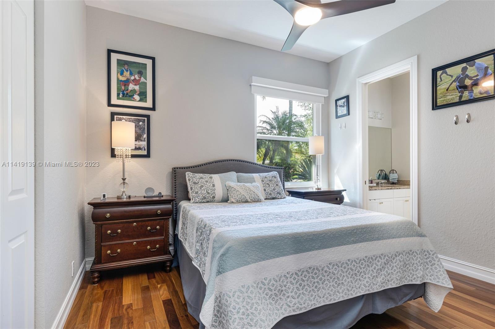 7982 Northwest 109th Lane Parkland, FL 33076 - Photo 19 of 71 a bedroom with a bed and a lamp on dresser