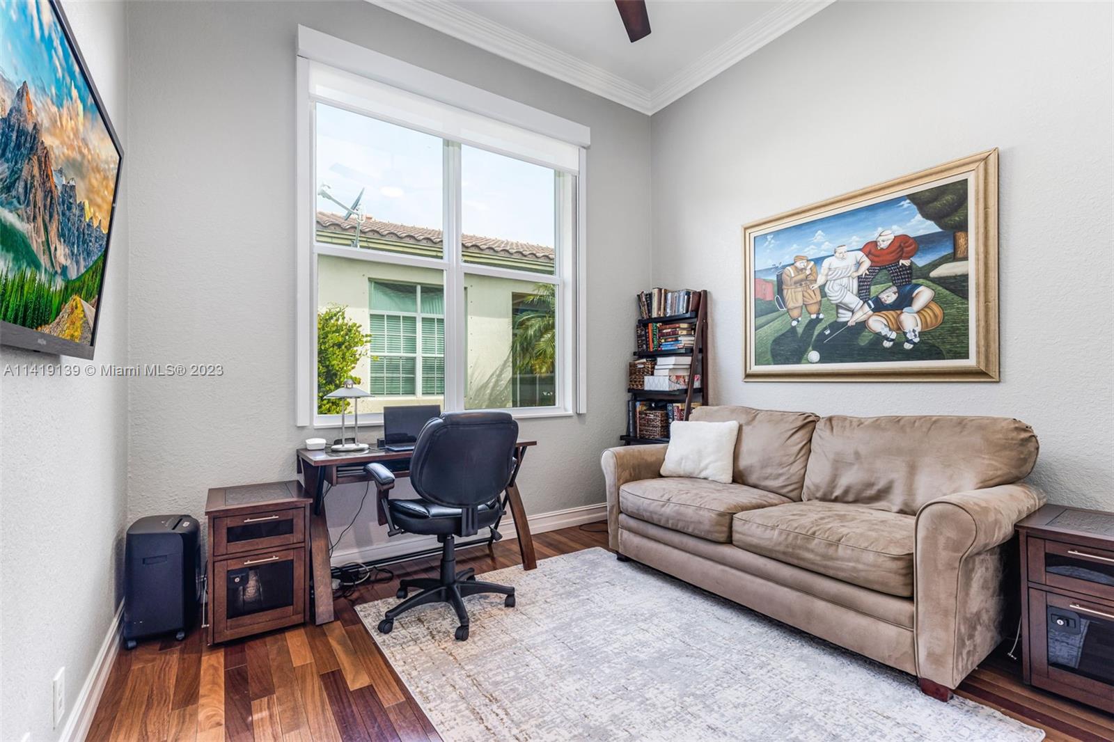 7982 Northwest 109th Lane Parkland, FL 33076 - Photo 21 of 71 a living room with furniture and a flat screen tv with wooden floor