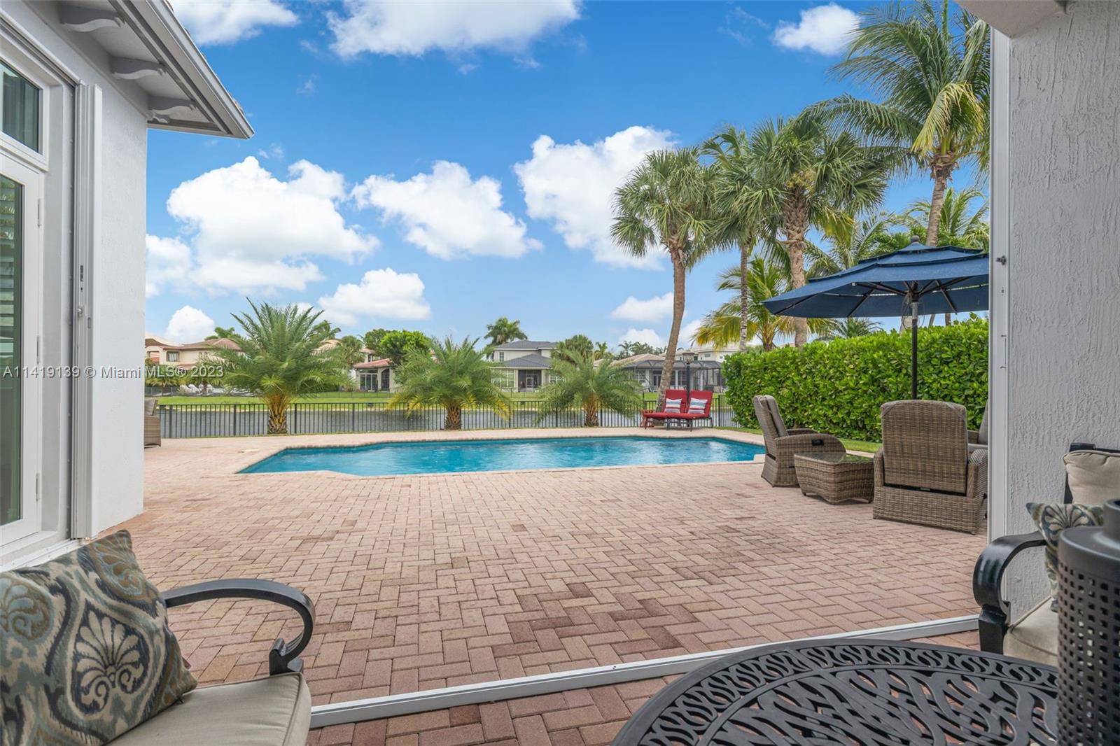 7982 Northwest 109th Lane Parkland, FL 33076 - Photo 24 of 71 a view of swimming pool with outdoor seating and plants
